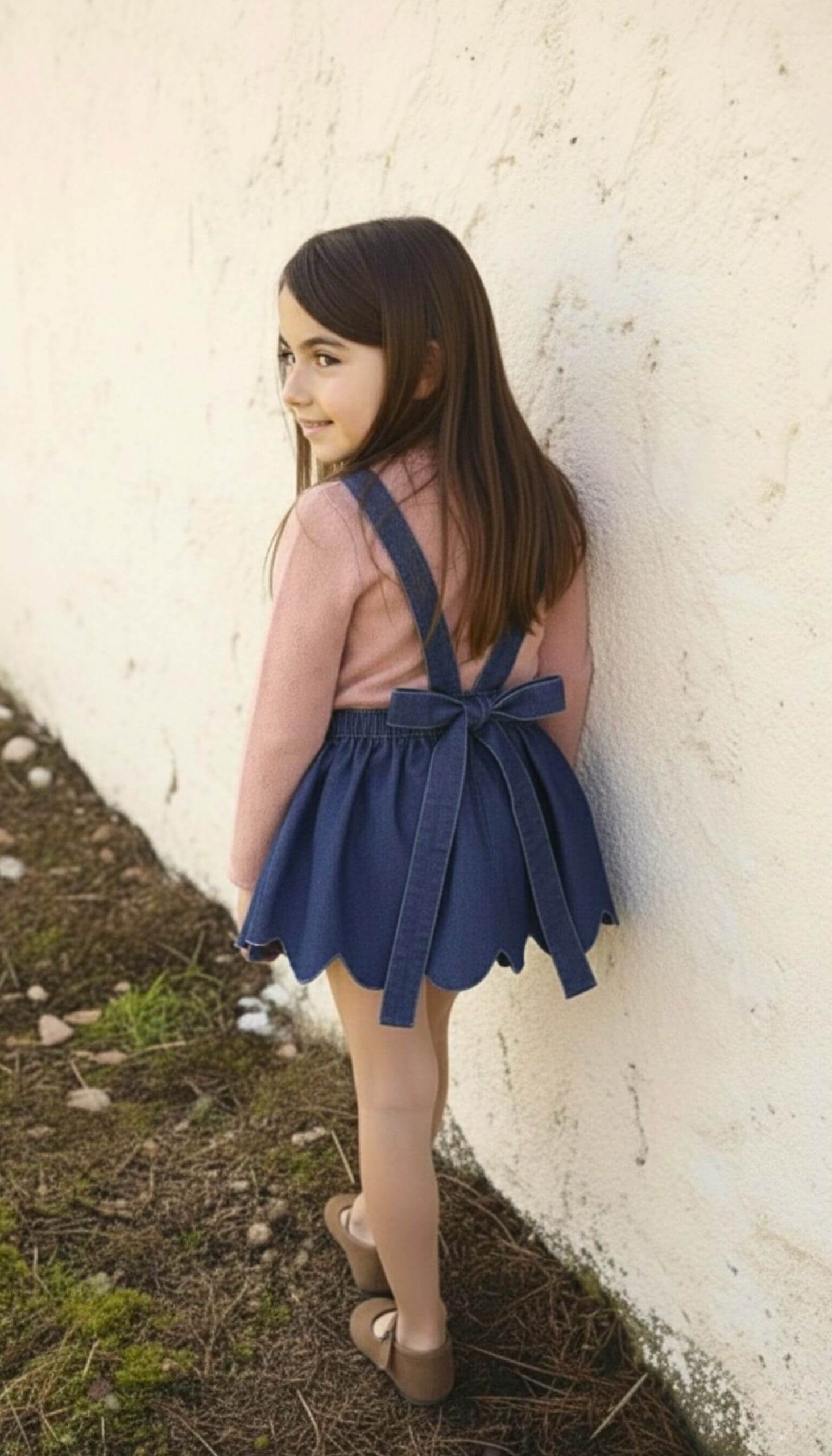 Parte trasera del jersey de punto rosa para niña.